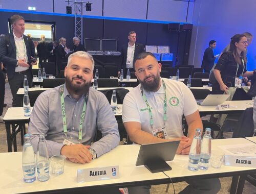 A photo of Karim Kerbouche and Nassim Boulakdem sitting at the Algeria desk at the IIHF Annual Congress